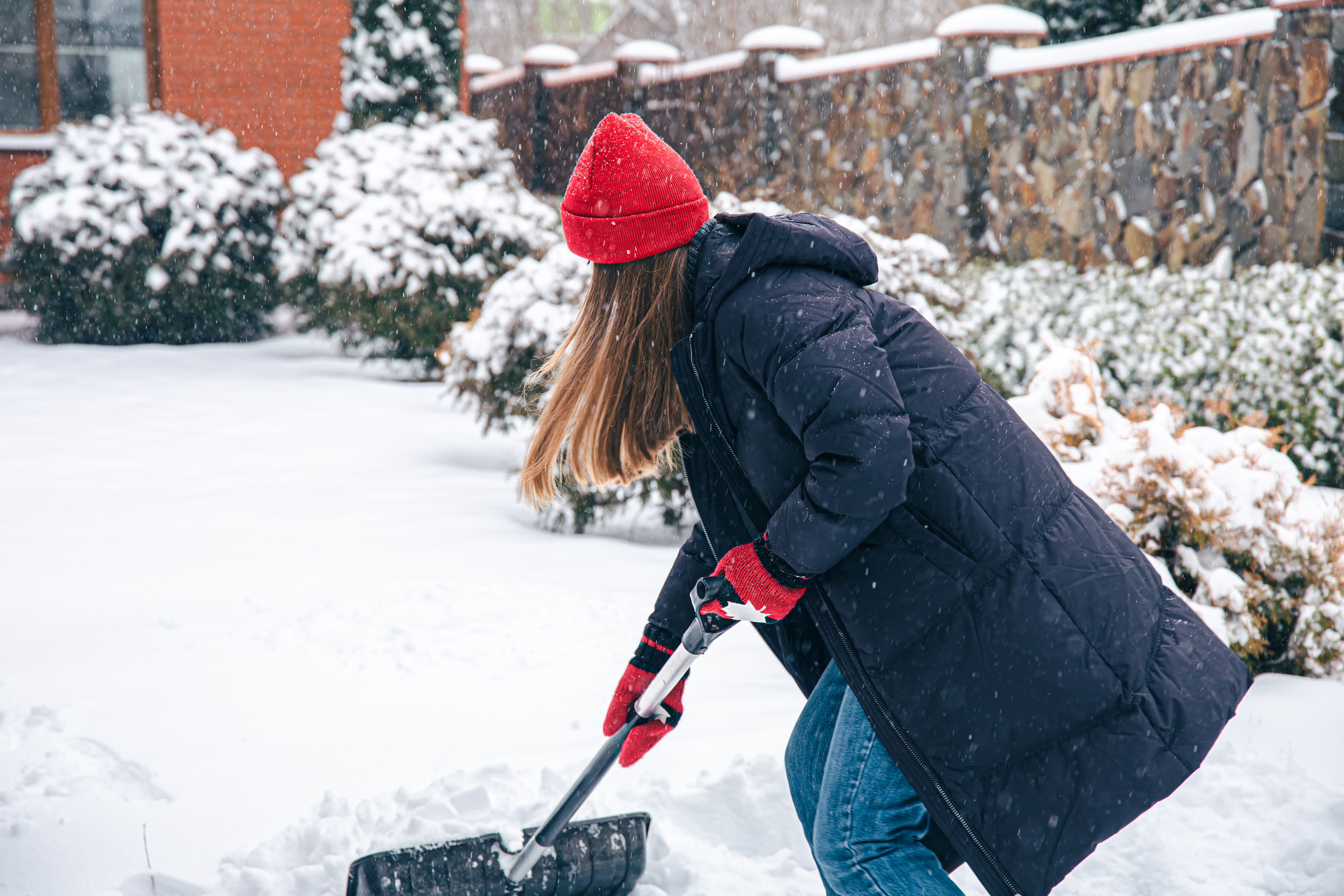 jeune-femme-nettoie-neige-dans-cour-par-temps-neigeux